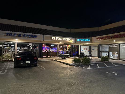 Outside strip mall with two outdoor table options