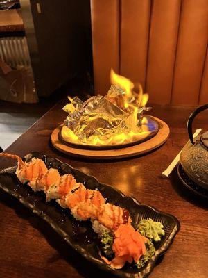 Spider roll ( front) and volcano roll( flaming in back)