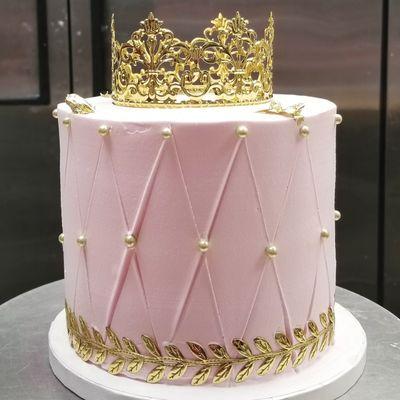 Tiny gold and pink crown cake. Part of a three-tier quinceañera cake.