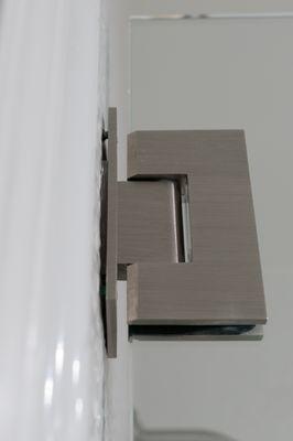 Installed hinge with a gap that shows the screws.