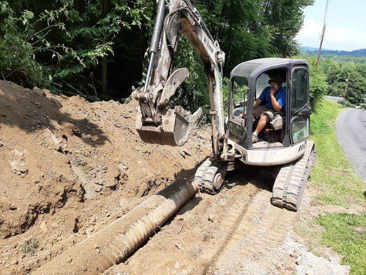 Culvert pipe replacement and subsequent repaving of the apron.