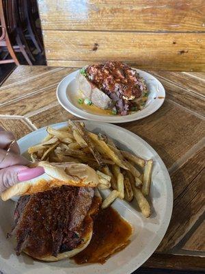 brisket sandwich with fries and a loaded potato.