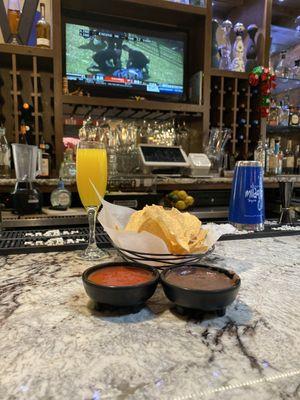 Seat @ the bar with a mimosa, chips, salsa, and bean dip