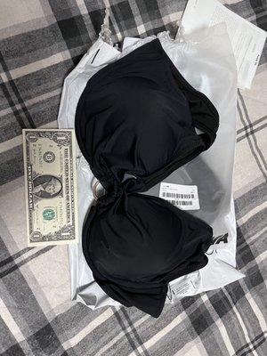 "2X" bikini top beside a dollar bill for size reference