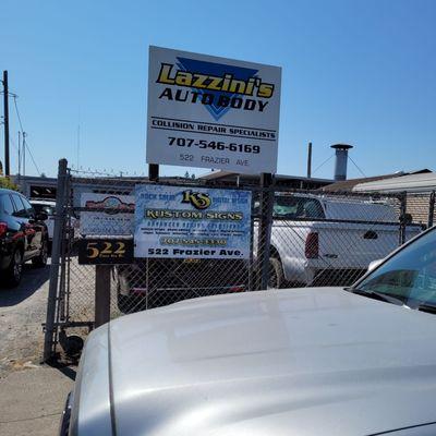 The sign and gate for Lazzini's Auto Body. It's easier to spot the Hells Angel's headquarters:  safest spot in town. Very quiet street.