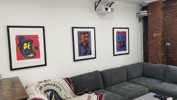 Photo from a collector's home with three custom framed pieces