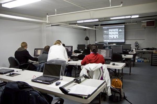 the basement digital lab features multiple workstations. professional printers, and is located next adjacent to the gallery.