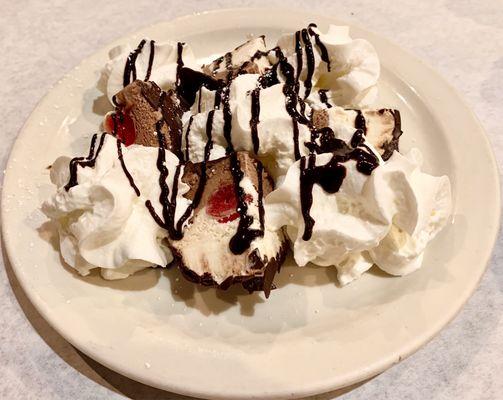 Tartufo-Vanilla & Chocolate IceCream in a Hard Chocolate Shell, Whipped Creme, Chocolate Syrup & Cherry