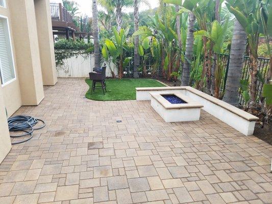 Ashlar pattern pavers, seating wall and fire pit by Genesis Stoneworks