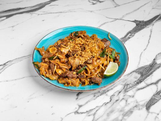 Our Pad Thai, a spicy and sweet sticky noodle dish with veggies and a meat of your choice. Try thai!