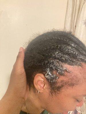 Her braids with all the glue on them and her bald sides.