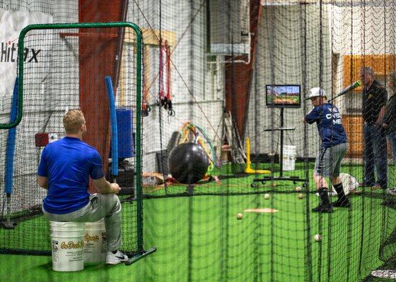 Our hitting instructor, Korey, utilizing Hittrax to teach his lesson. Hittrax records each hit and gathers stats for progress tracking.