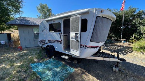 camper setup next to parents house for easy hookups