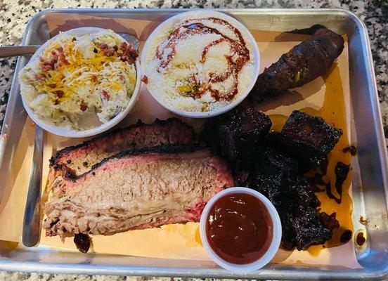 Two meat plate $19 brisket, meat candy, street corn, loaded potato salad. Texas Twinkie