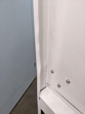 The condition of the door after Abbott West replaced the latch after a break in.