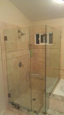 Frameless shower enclosure