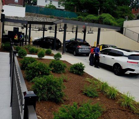 The crew taking orders outside, 3 cars deep for drive-thru - - 7/25/2024