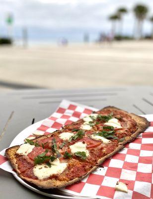 Margarita pizza on thin flatbread crust