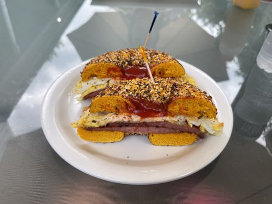 Pork Roll, egg and cheese on an everything egg bagel / salt, pepper + ketchup