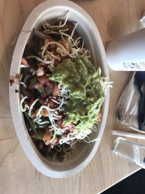 Half chicken Half Barbacoa burrito bowl with Guacamole and Cheese. Delicious!