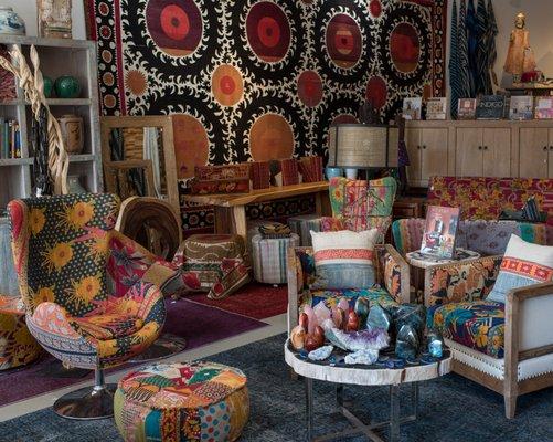 Interior shot of our River Arts District store. Featuring mid century chairs, floor pillows, gems, and accessories.