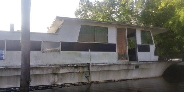 One of many "Zombie boats" at the Big Ridge Yacht club.. there's a larger sunken houseboat underwater next to this one.