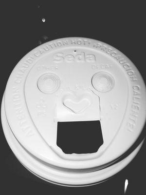 Look at the lids for the coffee cups. Its a face with a heart nose