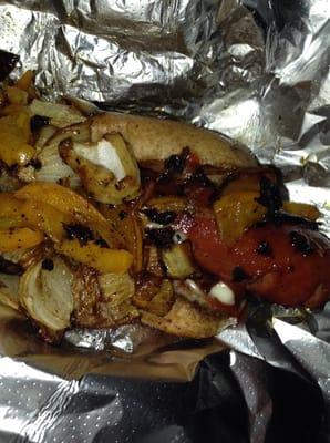 Bacon hotdog with peppers and onions.