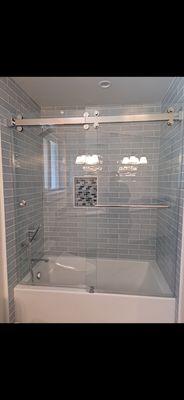 Sliding frameless shower glass