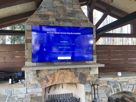 TV MOUNTED OVER STONE FIRE PLACE.