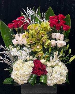 Black box set with red and white roses and green cymbdium orchids with white hydrangeas