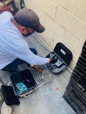 Our technician Armando servicing one of our rodent bait stations.