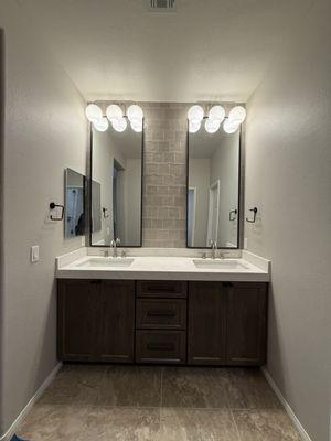 Reinstalled lighting, hung mirrors and installed new bathroom towel rings