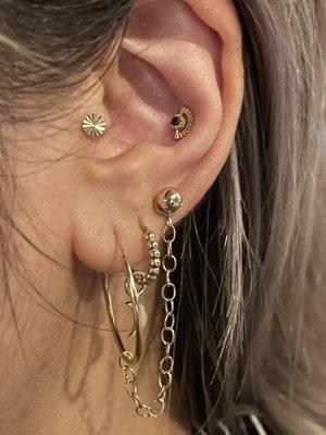 14k gold disc in tragus and sun rays 14k threadless end with black diamond in conch