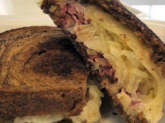 Grilled Reuben - corned beef, sauerkraut, swiss cheese, black pepper 1000 island on marbled rye