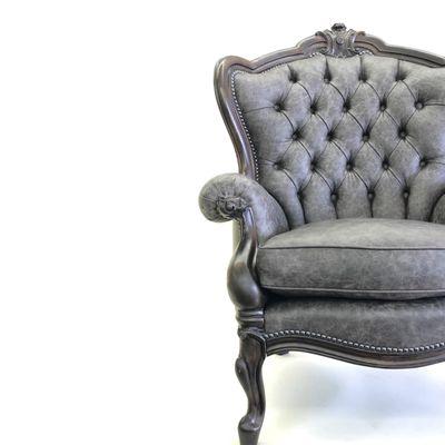 Gorgeous tufted chair upholstered in a beautiful smoky leather.