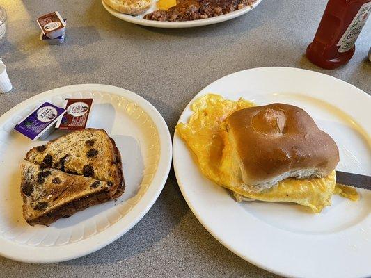 Breakfast sandwich on a hard roll. Raisin bread extra