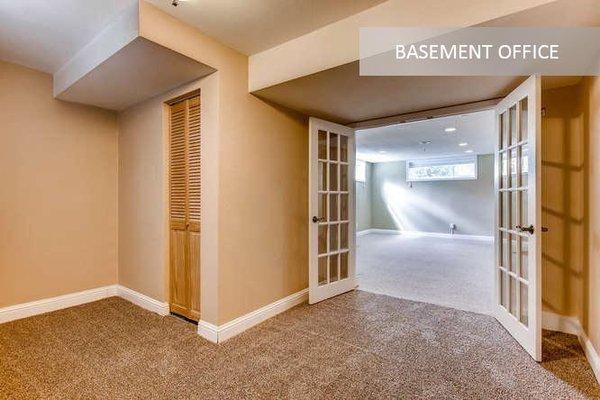 We reimagined a tired, 1960s basement with this office, raising most of the ceiling, and adding copious storage and inviting French doors.