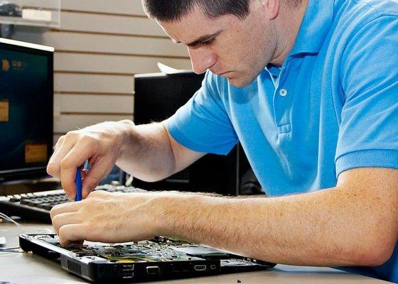 Jason Kinner repairing laptop computer