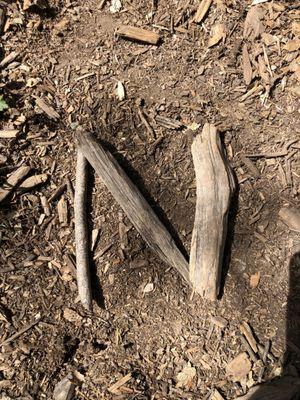 working on letter formation with natural materials to help kids improve academic skills