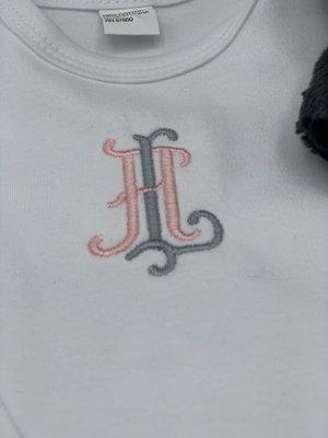 Monogrammed infant gown.