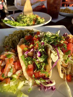 Shrimp tacos and the freshest chunky guacamole in the background - highly recommend!