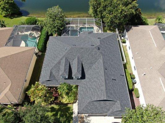 Overhead view of gray roof with covered pool in the background.