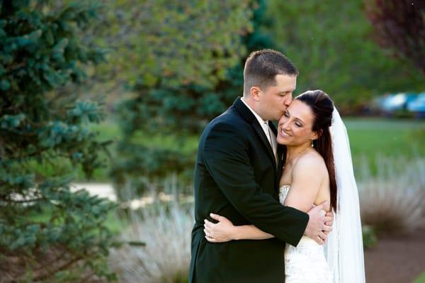 Leise Jones Photography; A bride and groom embrace during a couple's photography session in their outdoor venue in Boston, Ma.