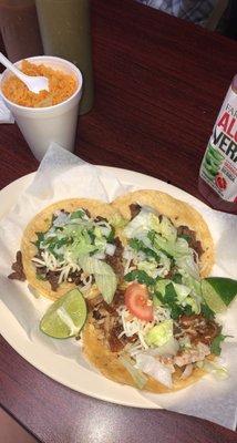 Chicken taco, asada taco, and tripe taco with a side of rice