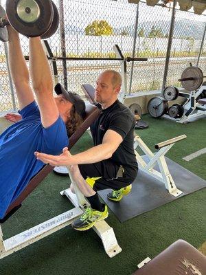 Coach Mike spotting a dumbbell chest press.  Personal training.