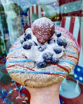 4th of July stuffed cookie 2021 (blueberry base mixed with white chocolate chips, lavender cream cheese, topped with white mousse & berries)