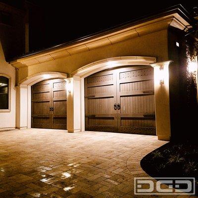 Newport Beach, CA - Luxury garage doors in a Mediterranean design. Custom designed and handcrafted in rustic alder wood.