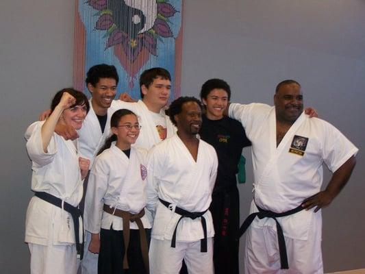 Select martial arts instructors with four recently promoted student black belts in our studio.