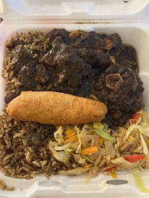 Large oxtails with rice & beans and cabbage (plus fried plantain, I'm guessing?)